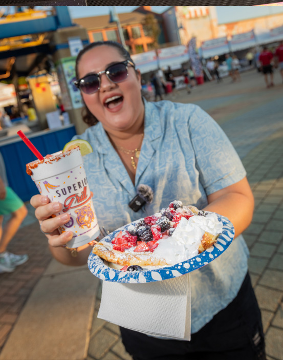 Girl holding a large funnel cake at the Red River Revel.